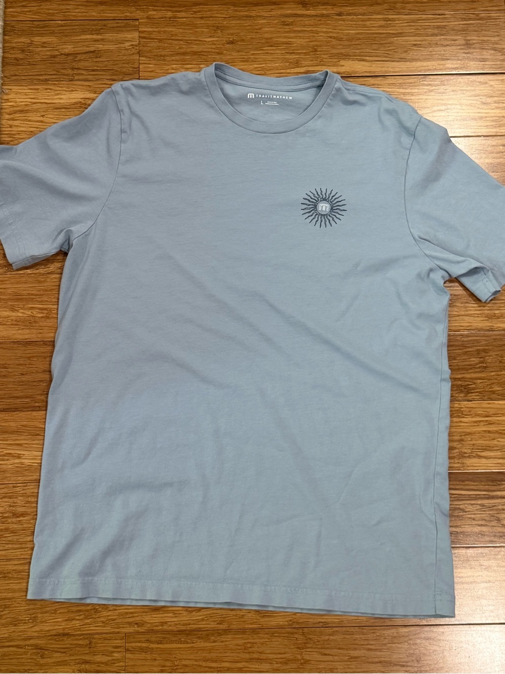 Travis Mathew Light Blue Crewneck with Sun Graphic